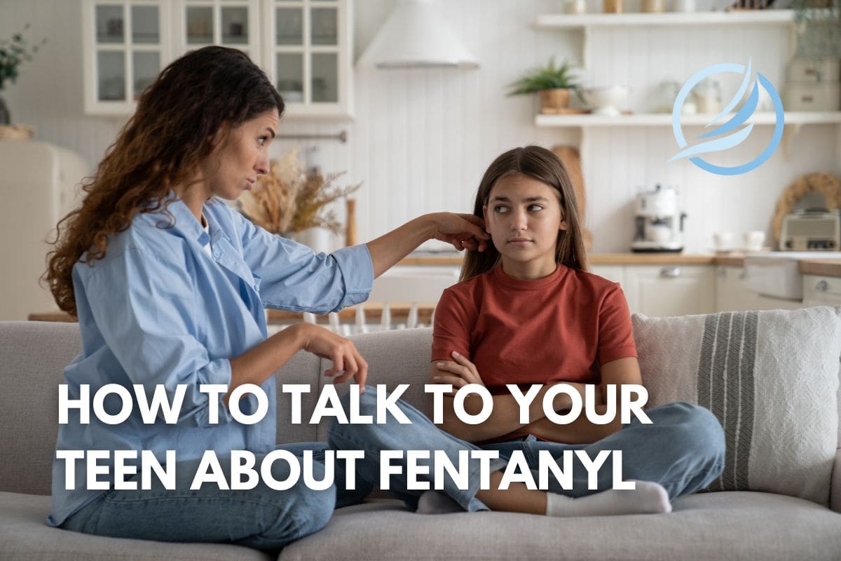 an image of a mother and her teenage daughter sitting on a couch discussing the dangers of fentanyl.